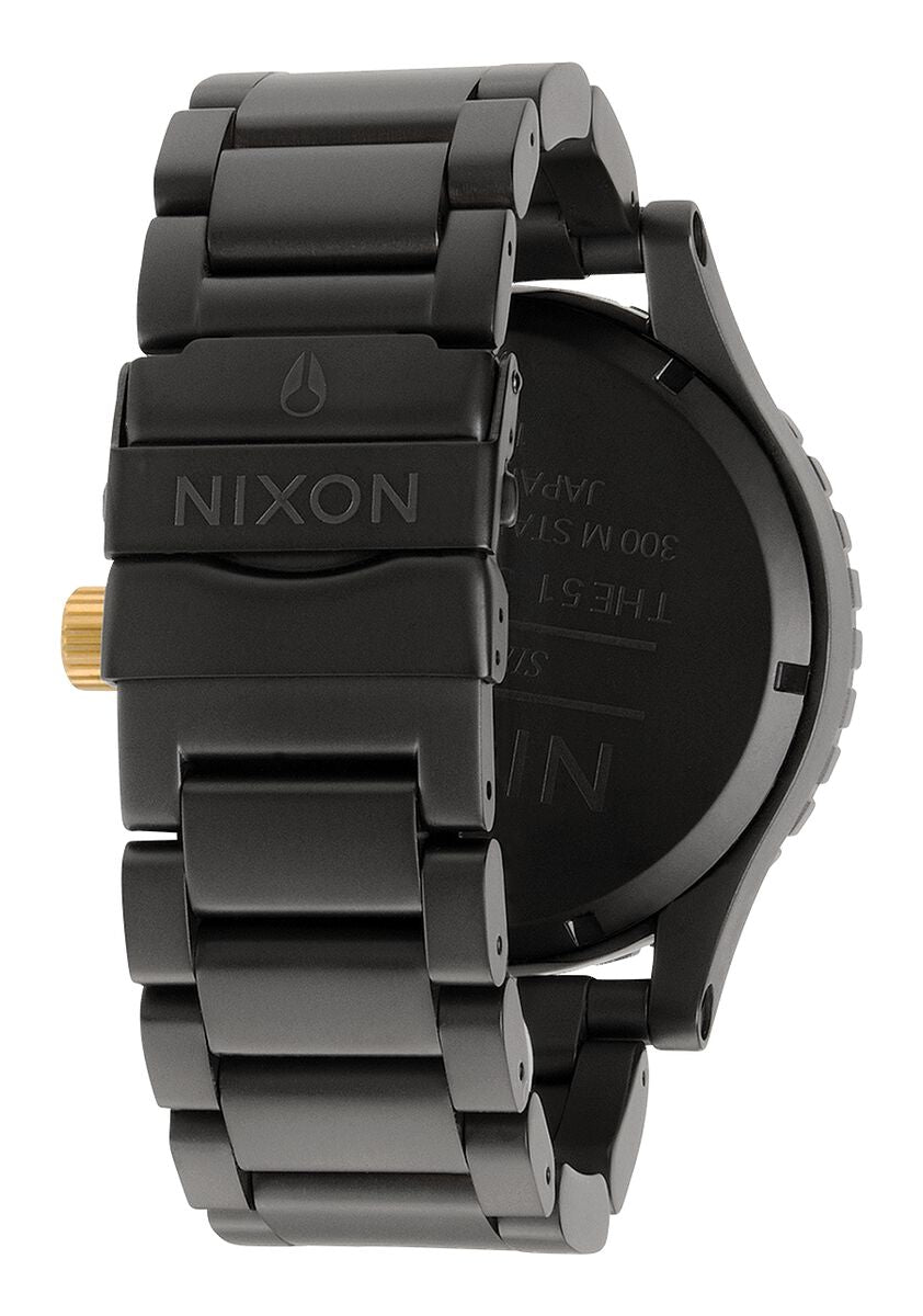 Side view of Nixon 51-30 watch showing black metal bracelet and case profile with gold crown