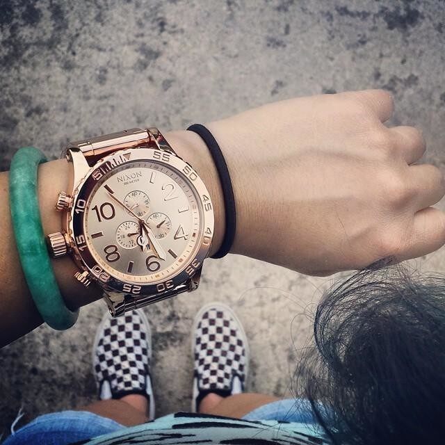 Nixon 51-30 Chrono rose gold watch worn on wrist with casual styling