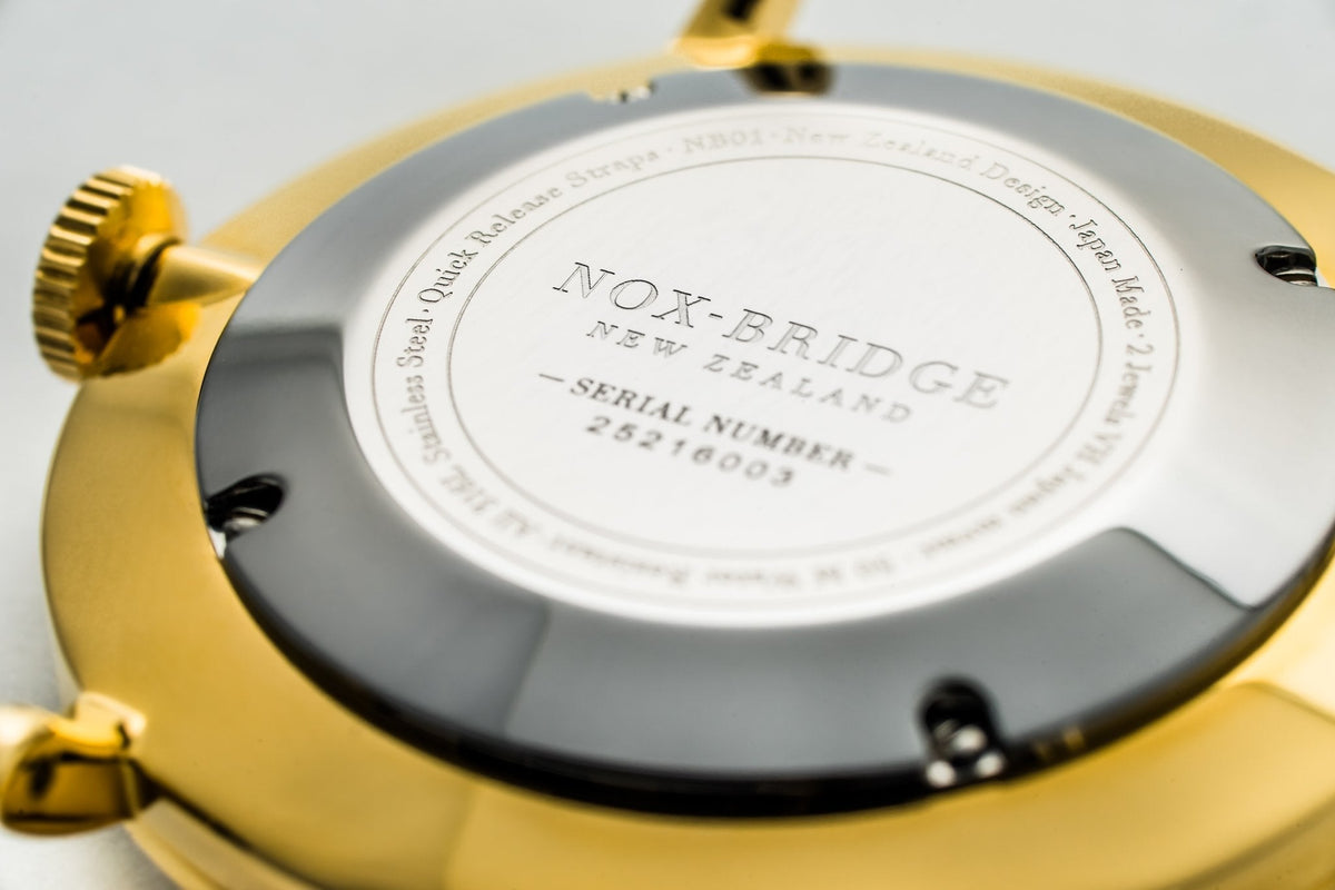 Caseback showing Noxbridge engraving and serial number on gold case