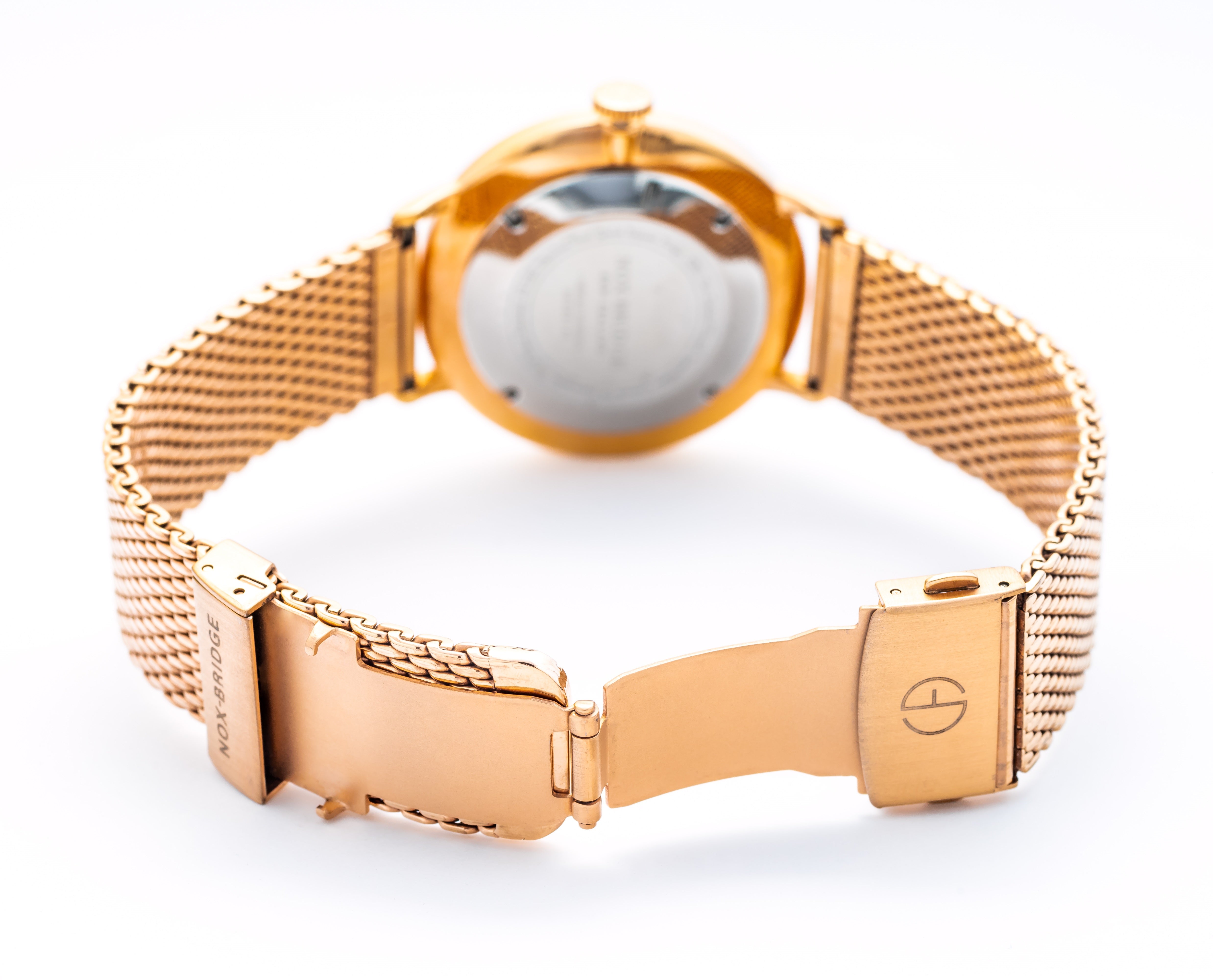 Noxbridge Phoenix watch on wrist with rose gold mesh bracelet and white dial