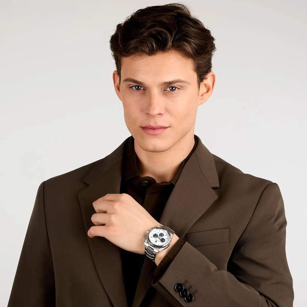Man wearing brown blazer with Maserati Velocità watch on wrist
