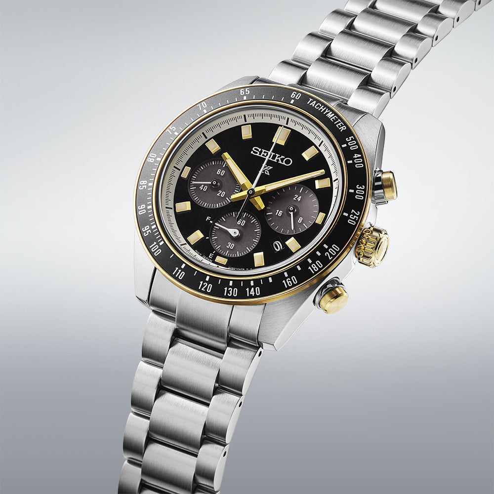 Seiko Prospex Speedtimer watch at angle showing steel bracelet and gold chronograph pushers