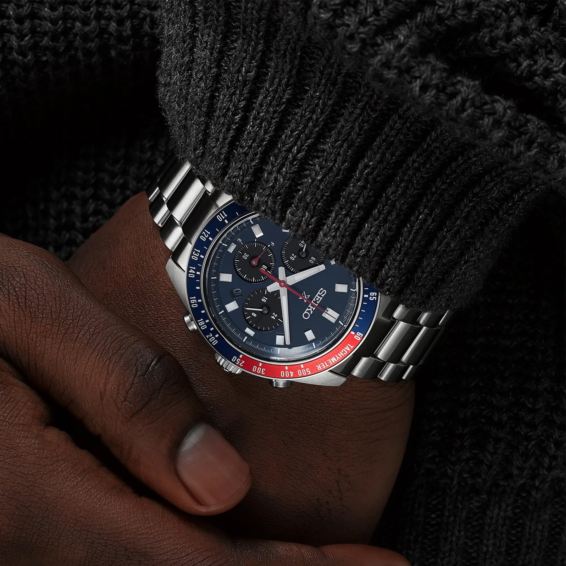 Seiko Pepsi Speedtimer SSC913P1 worn on wrist with dark dial and blue-red bezel
