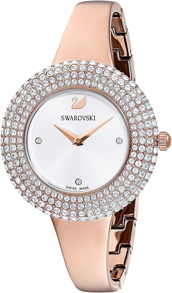 Angled view of Swarovski rose gold watch with crystal bezel and metal strap detail