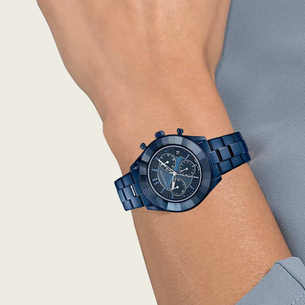 Swarovski blue metal chronograph watch worn on wrist