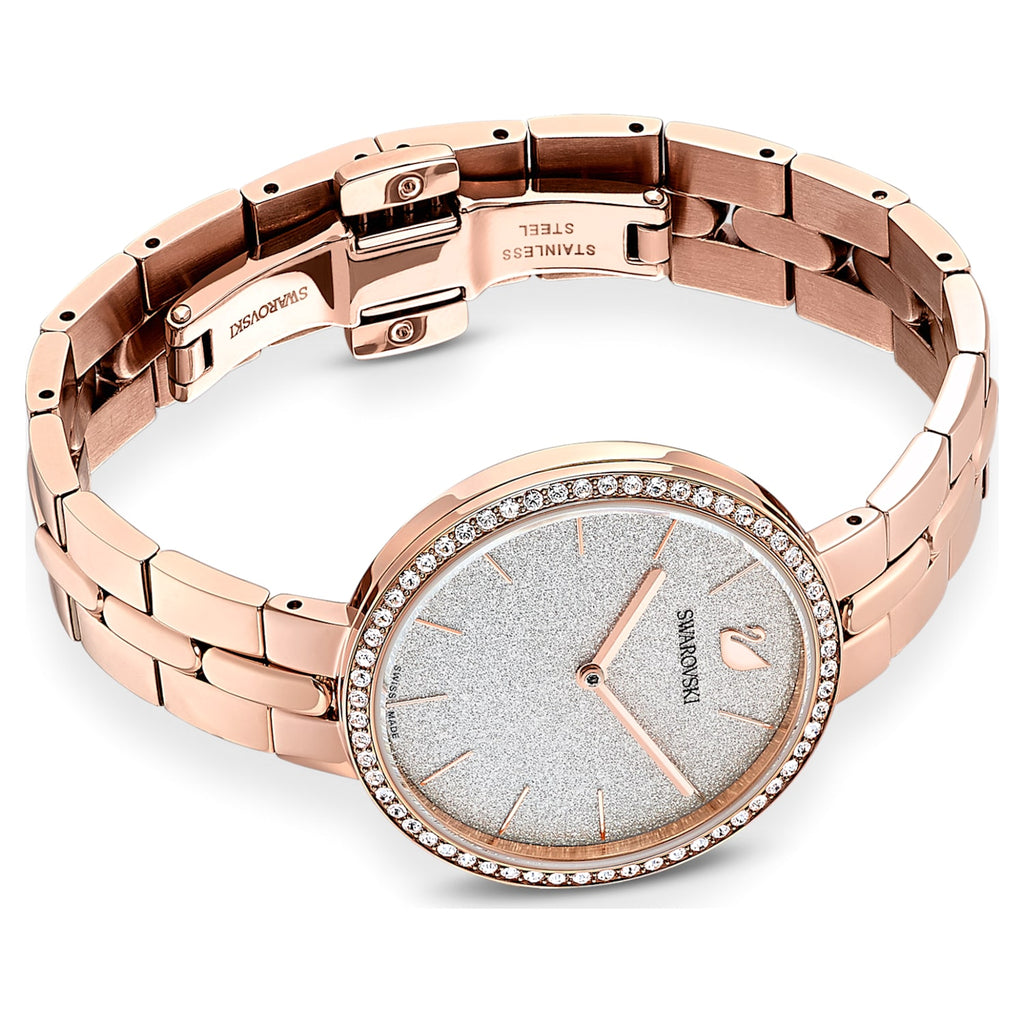Swarovski Cosmopolitan rose gold watch with metal bracelet laid flat