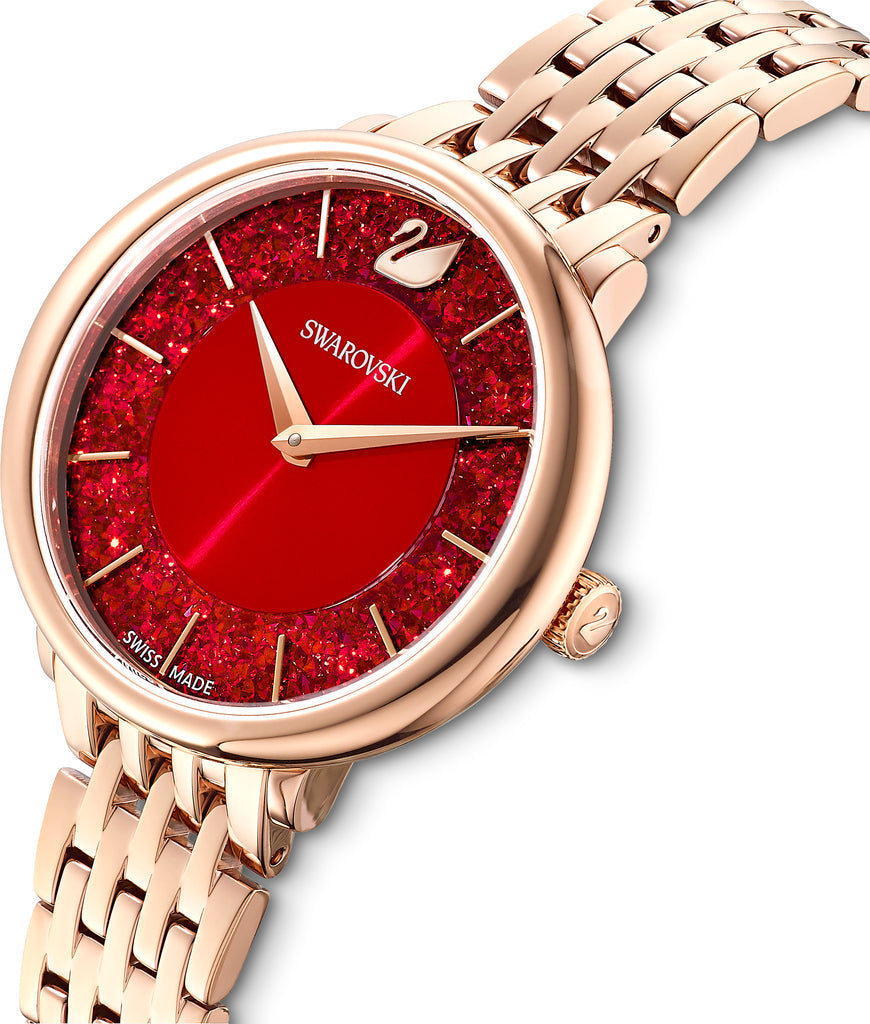 Crystalline Chic watch angled view showing red crystal-studded dial and rose gold-tone bracelet
