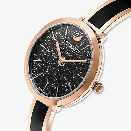 Angled view of Swarovski Crystalline Delight watch with black glitter dial and two-tone bracelet