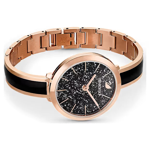 Flat lay of Swarovski Crystalline Delight watch showing full two-tone metal bracelet and black dial
