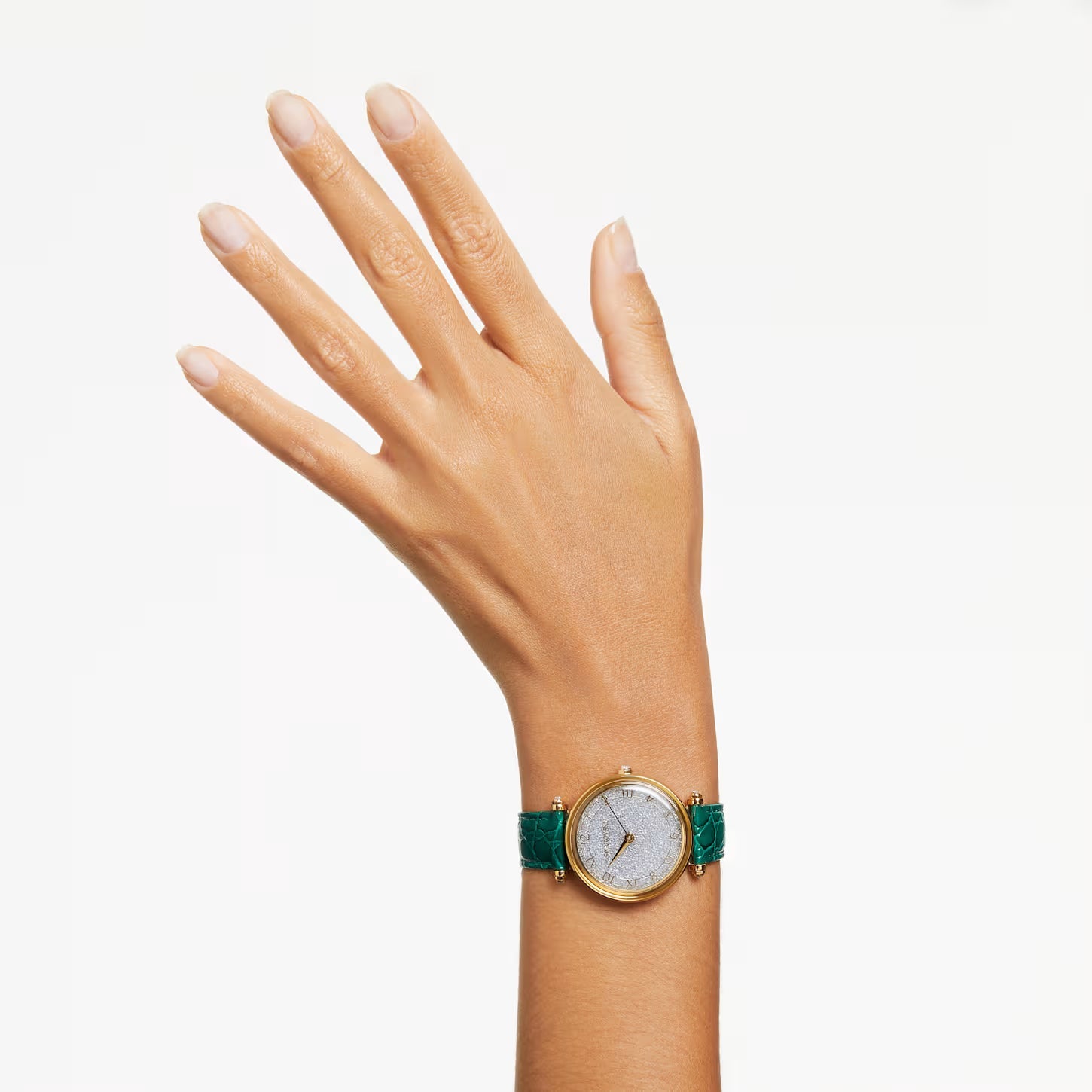 Crystalline Wonder watch worn on wrist with silver dial and green leather strap