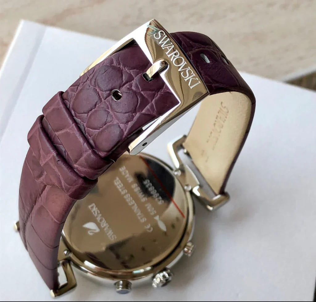 Swarovski Era Journey caseback showing purple leather strap with Swarovski branding and metal clasp