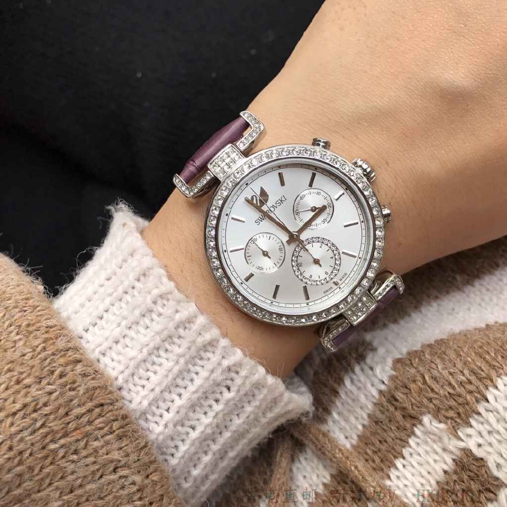 Swarovski Era Journey chronograph on wrist with purple leather strap and crystal-studded case