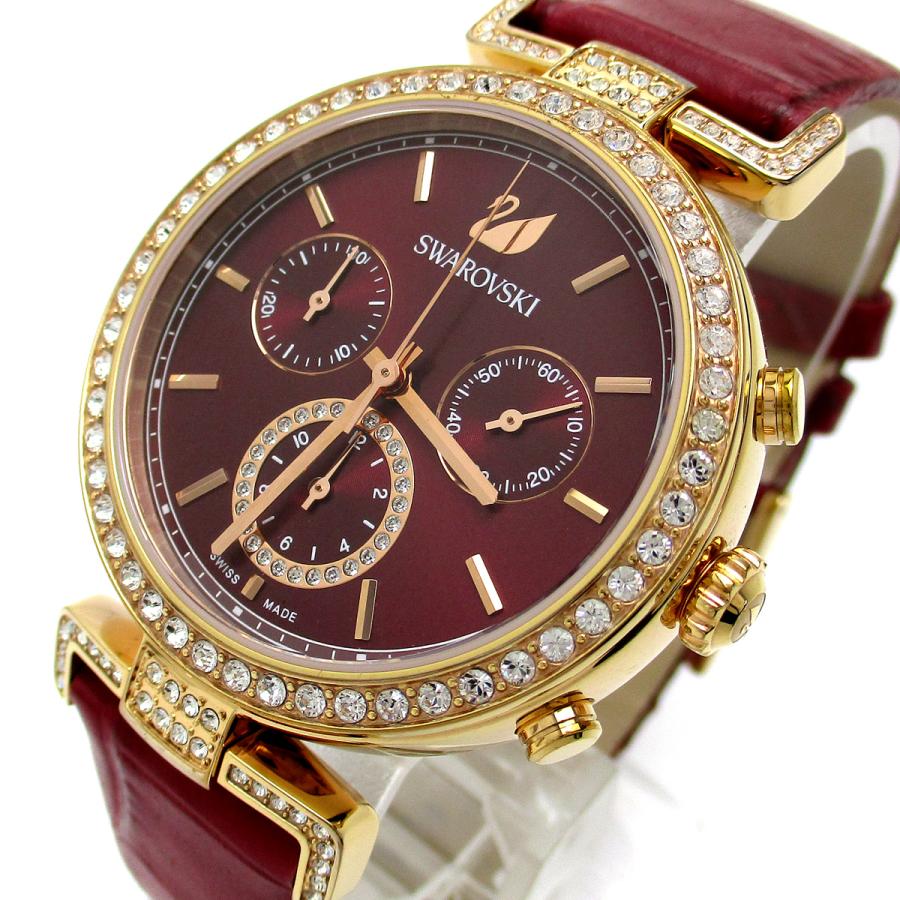 Close-up detail of red dial with rose gold hands, hour markers, and three chronograph subdials