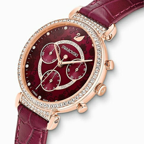 Angled view of purple chronograph watch with octagon crystal, gold-tone case with crystal bezel, and burgundy leather strap
