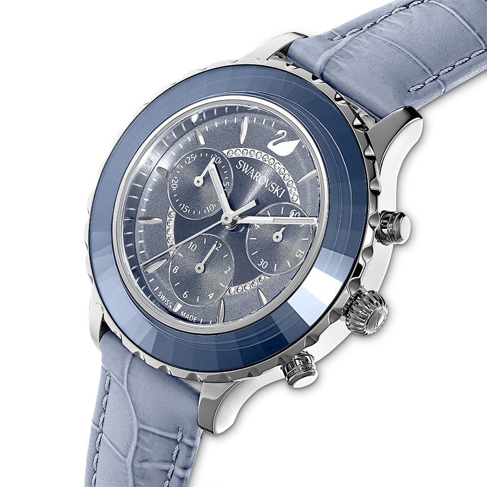 Swarovski Octea Lux Chrono watch at angle showing blue bezel, indigo dial with chronograph subdials, and blue leather strap
