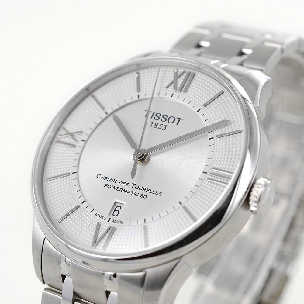 Tissot Chemin Des Tourelles watch angled view showing dial detail with Roman numerals and date window