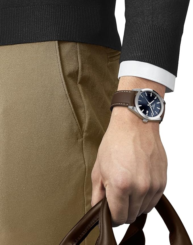 Tissot Gentleman watch worn on wrist with blue dial and brown leather strap