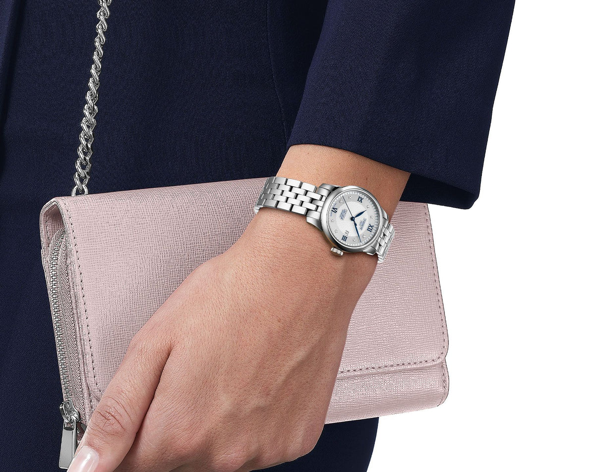 Tissot Le Locle women's automatic watch worn on wrist with silver dial and steel bracelet