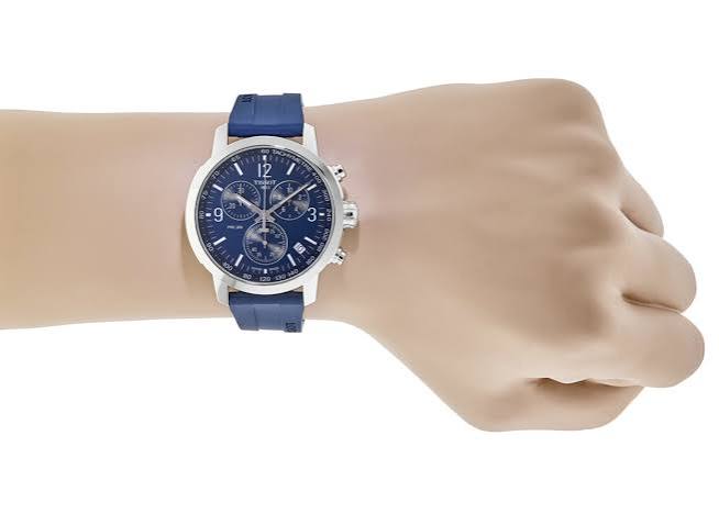 Tissot PRC 200 Chronograph watch worn on wrist with blue rubber strap