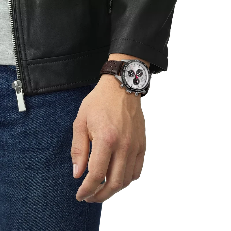Tissot PRS 516 chronograph worn on wrist showing silver dial and brown leather strap