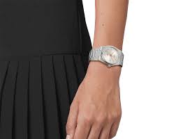Tissot PRX 35mm watch worn on wrist, showing silver dial and stainless steel bracelet