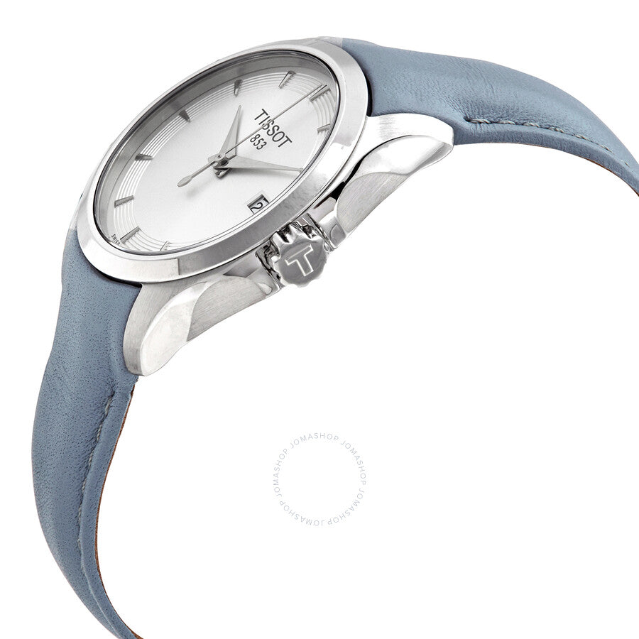 Tissot T-Classic Couturier watch angled view showing silver dial and light blue leather strap