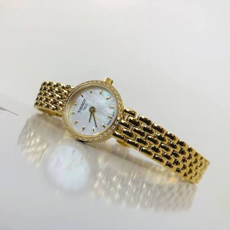 Tissot T-Lady Lovely watch on wrist displaying mother of pearl dial and diamond bezel