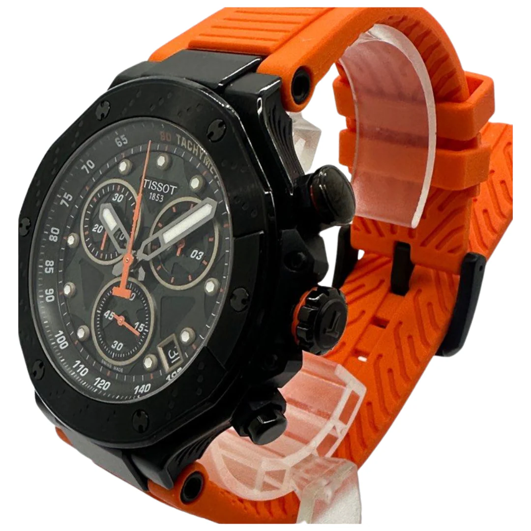 Tissot T-Race chronograph watch worn on wrist, displaying black dial with orange hands and strap
