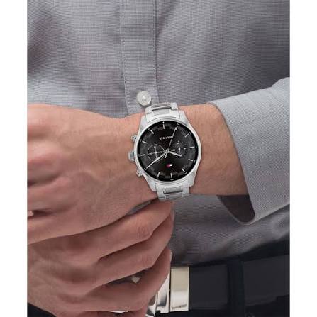 Tommy Hilfiger stainless steel watch worn on wrist with black dial and chronograph subdials