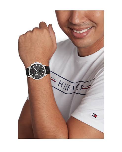 Tommy Hilfiger chronograph watch worn on wrist with black strap and silver case