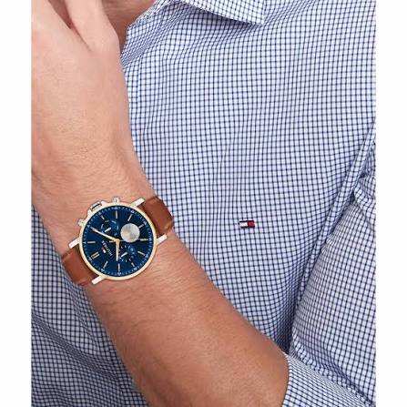 Tommy Hilfiger chronograph watch worn on wrist with blue checkered shirt