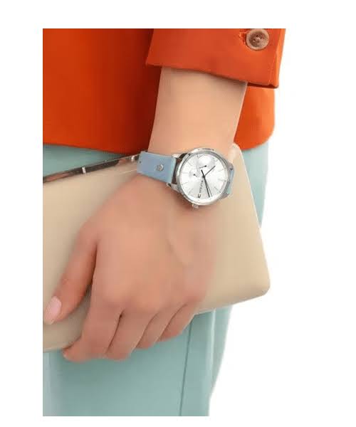 Tommy Hilfiger 1782023 watch worn on wrist with blue strap against colorful outfit