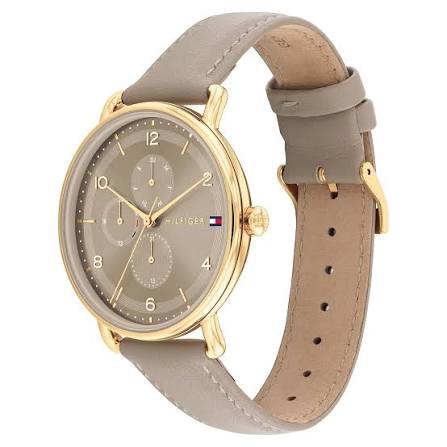 Side angle view of Tommy Hilfiger women's watch with beige leather strap and gold case