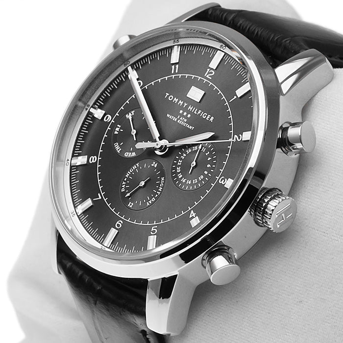 Close-up of grey dial with Tommy Hilfiger branding and chronograph sub-dials