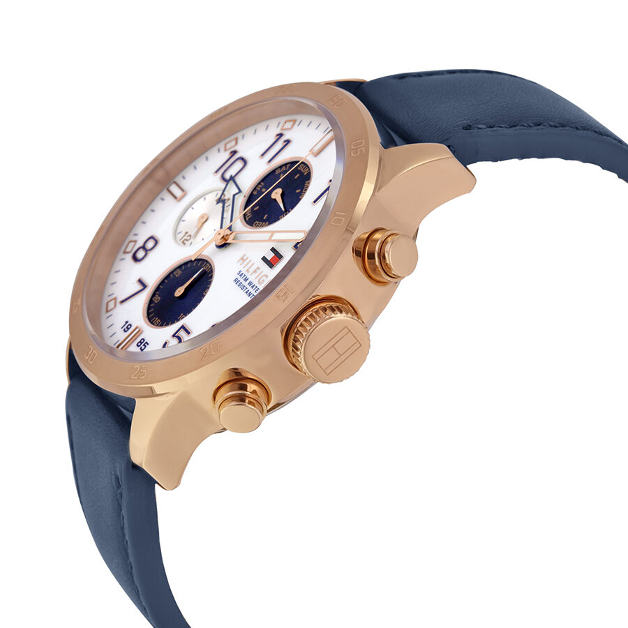Side angle view of Tommy Hilfiger chronograph watch showing rose gold case, white dial, and blue leather strap