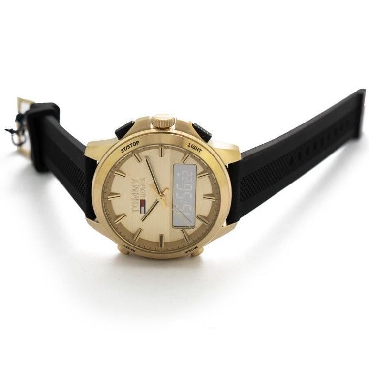 Tommy Hilfiger gold dual time watch on wrist with black silicone band