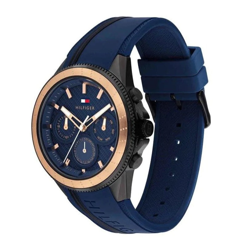 Side angle view of Tommy Hilfiger Aiden chronograph with blue rubber strap and rose gold case