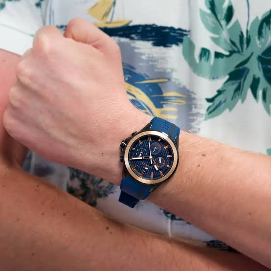 Tommy Hilfiger Aiden chronograph watch worn on wrist showing blue dial and rose gold bezel