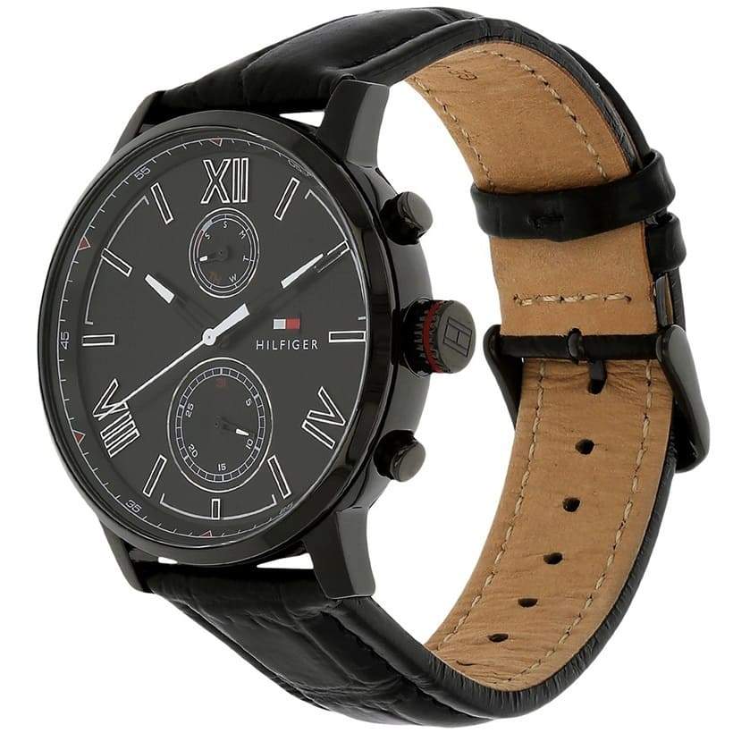 Tommy Hilfiger Alden watch showing black case, tan leather strap, and dual subdials from angled view
