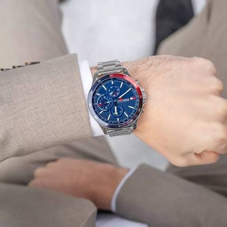 Tommy Hilfiger Bank chronograph watch worn on wrist with blue dial and silver steel bracelet