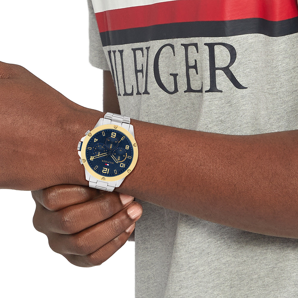 Tommy Hilfiger Blaze chronograph watch worn on wrist with blue dial and gold bezel