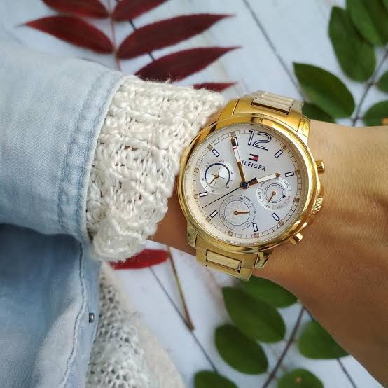 Tommy Hilfiger Claudia gold chronograph watch worn on wrist with white sleeve