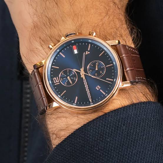 Tommy Hilfiger Daniel chronograph watch worn on wrist with brown crocodile-embossed leather strap