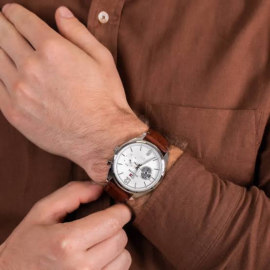 Tommy Hilfiger Deacon watch worn on wrist with brown leather strap