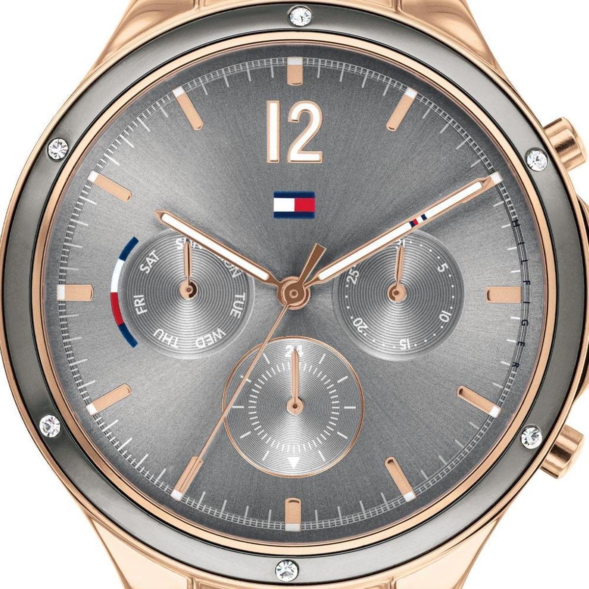 Close-up of grey dial with three subdials, rose gold accents, and Tommy Hilfiger logo
