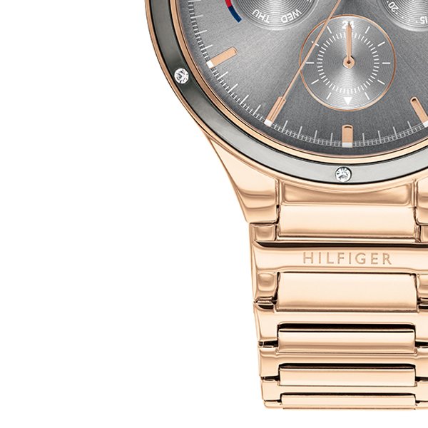 Side profile showing rose gold-tone case, bezel, and three-link metal bracelet