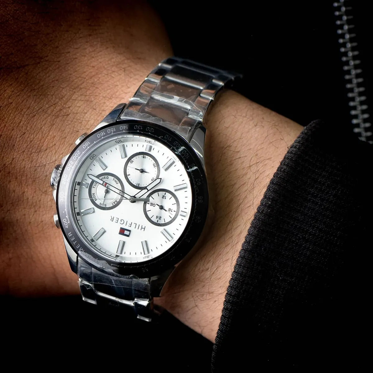 Tommy Hilfiger Hudson chronograph watch worn on wrist with white dial and silver bracelet