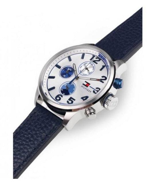 Tommy Hilfiger Jackson watch on wrist showing silver case, white dial with blue subdials, and navy leather strap