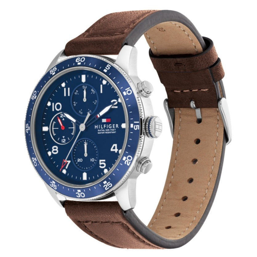 Side angle view of Tommy Hilfiger Jimmy watch showing brown leather strap with white stitching and tan lining