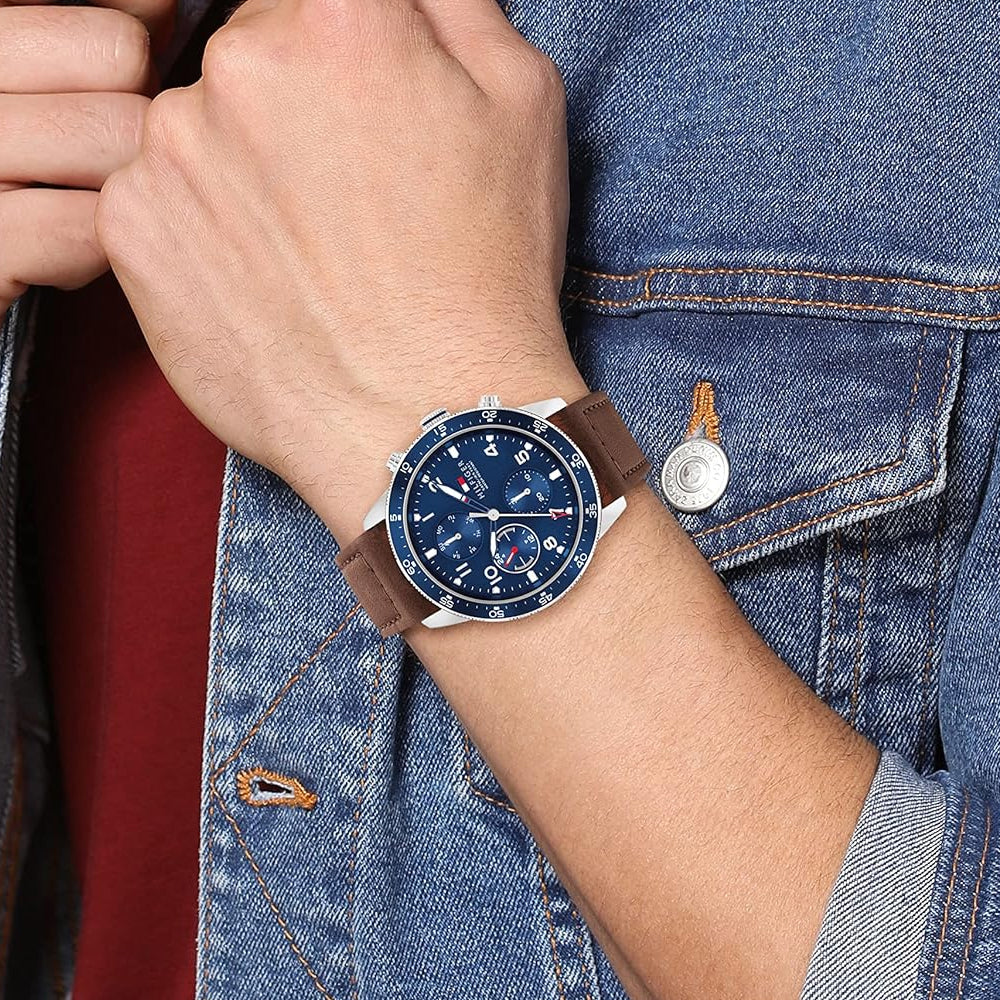 Tommy Hilfiger Jimmy chronograph watch worn on wrist with navy blue dial and brown leather strap